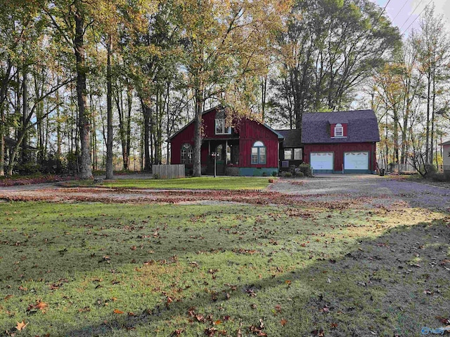 view of front of home with a front lawn and a garage