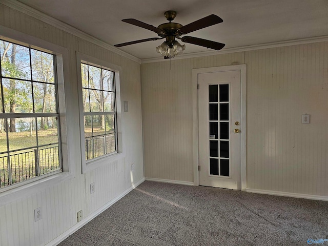 empty room with carpet, ceiling fan, and crown molding