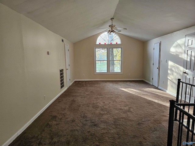 unfurnished living room featuring ceiling fan, dark carpet, and lofted ceiling