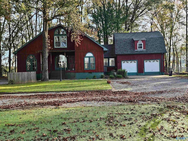 view of front property featuring a garage and a front yard