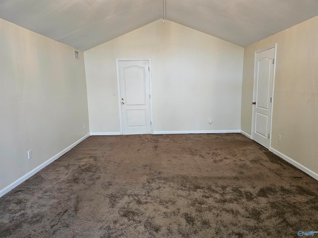 carpeted spare room with vaulted ceiling