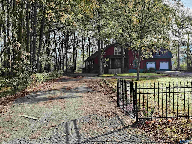 view of front of home featuring a garage and an outbuilding