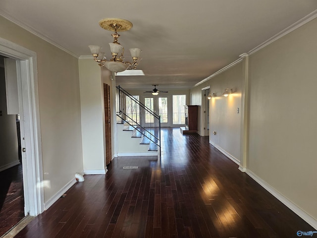 hallway featuring ornamental molding, dark wood-type flooring, and an inviting chandelier