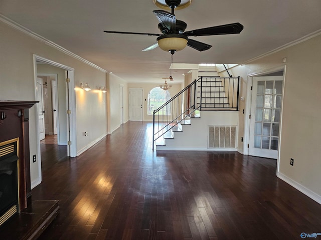 unfurnished living room with ceiling fan with notable chandelier, dark hardwood / wood-style floors, and ornamental molding