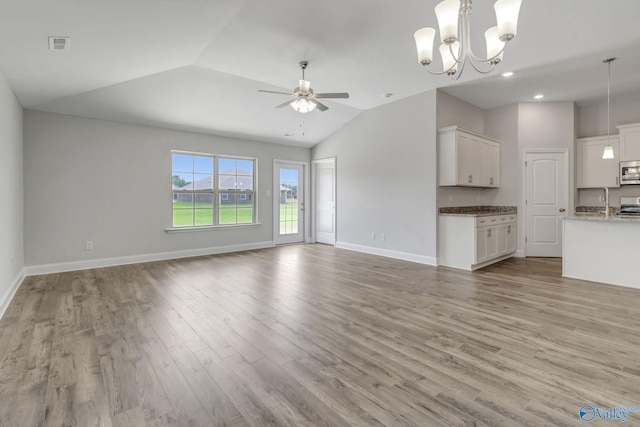 unfurnished living room with lofted ceiling, light hardwood / wood-style flooring, ceiling fan with notable chandelier, and sink