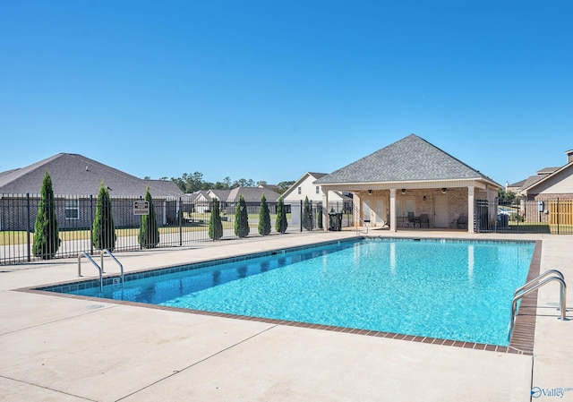 view of pool with ceiling fan and a patio area