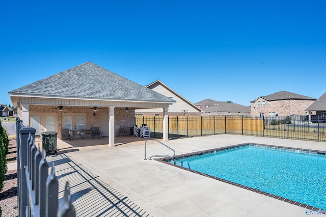 view of swimming pool featuring ceiling fan and a patio