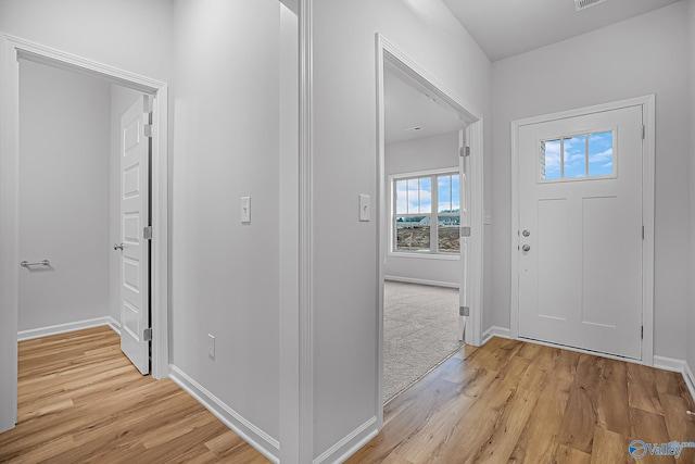 foyer entrance with light hardwood / wood-style flooring