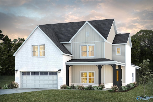 view of front facade with a garage, a lawn, and covered porch