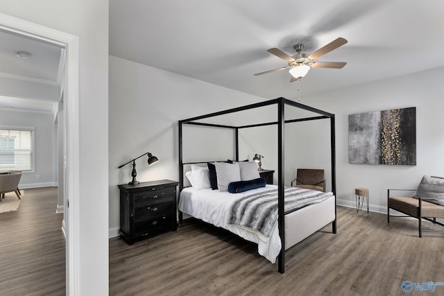 bedroom featuring dark hardwood / wood-style flooring, ornamental molding, and ceiling fan