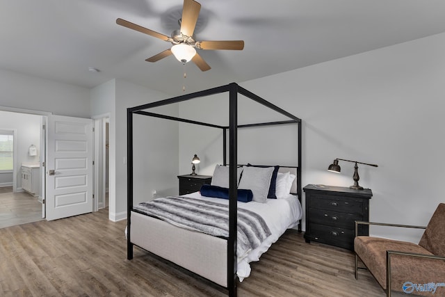 bedroom with hardwood / wood-style flooring, ensuite bathroom, and ceiling fan