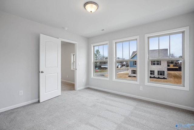 carpeted spare room with a wealth of natural light