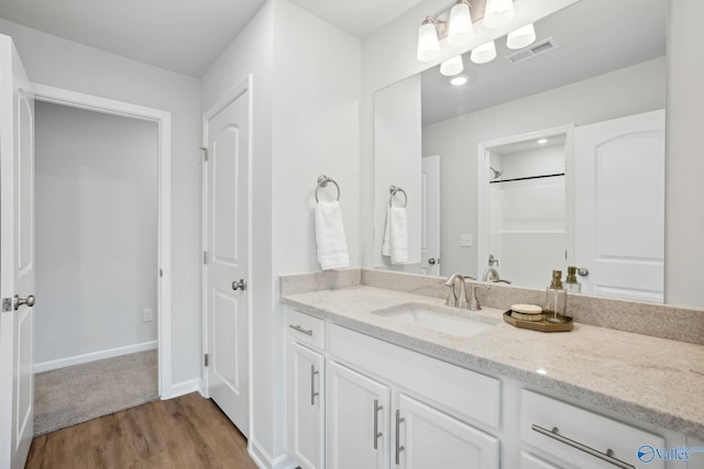 bathroom featuring vanity and hardwood / wood-style floors