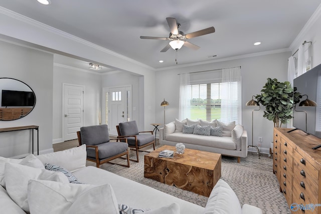 living room with crown molding and ceiling fan