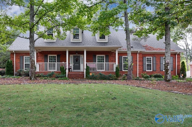 cape cod home featuring a front lawn and a porch