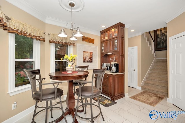 dining room featuring ornamental molding and an inviting chandelier