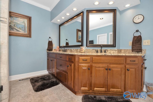 bathroom with crown molding, tile patterned flooring, and vanity