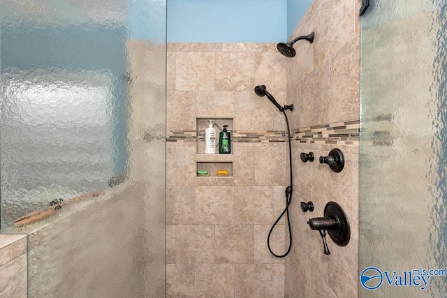 bathroom with tiled shower