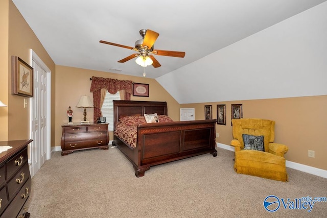 carpeted bedroom with vaulted ceiling, ceiling fan, and a closet