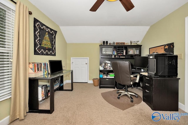 carpeted home office with lofted ceiling and ceiling fan