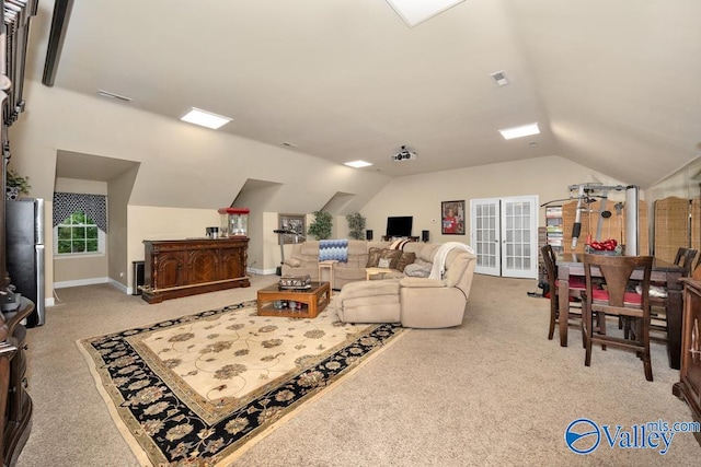 carpeted living room with vaulted ceiling