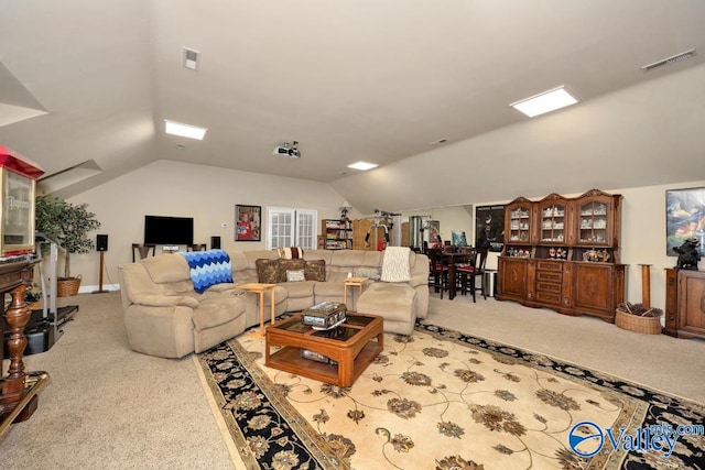 living room with carpet floors and vaulted ceiling