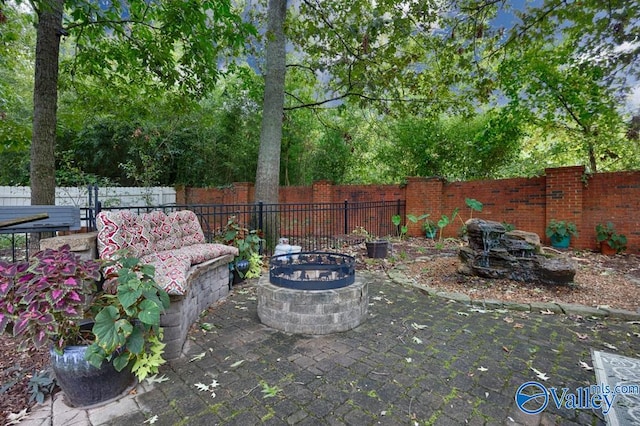 view of yard featuring a patio and an outdoor fire pit