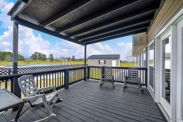 wooden terrace featuring a lawn