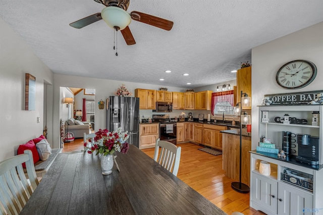 dining area with a textured ceiling, recessed lighting, a ceiling fan, and light wood finished floors