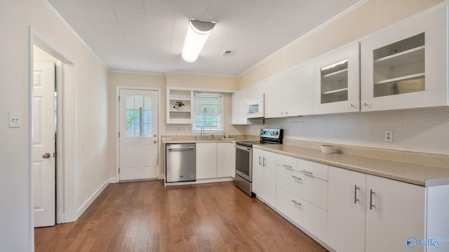 701 10th St NW, Huntsville, AL 35805 - kitchen with open shelves, white cabinets, dark wood-style floors, ornamental molding, and stainless steel appliances