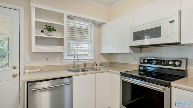 701 10th St NW, Huntsville, AL 35805 - kitchen with a healthy amount of sunlight, crown molding, appliances with stainless steel finishes, a sink, and white cabinets