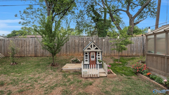 701 10th St NW, Huntsville, AL 35805 - view of yard featuring a fenced backyard and an exterior structure