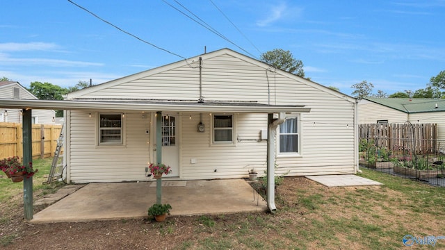 701 10th St NW, Huntsville, AL 35805 - rear view of property with fence, a patio, and a lawn