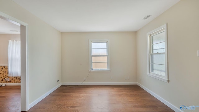 701 10th St NW, Huntsville, AL 35805 - unfurnished room with visible vents, baseboards, and wood finished floors