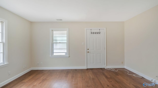 701 10th St NW, Huntsville, AL 35805 - empty room with baseboards, visible vents, and wood finished floors