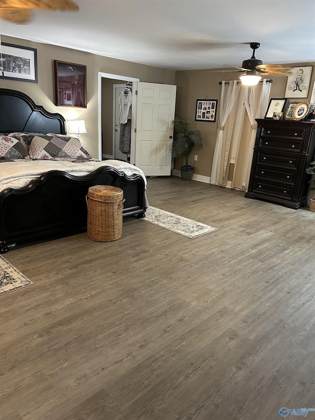 bedroom with ceiling fan and wood-type flooring