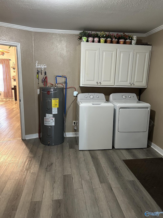 laundry area featuring cabinets, a textured ceiling, ornamental molding, washer and clothes dryer, and water heater