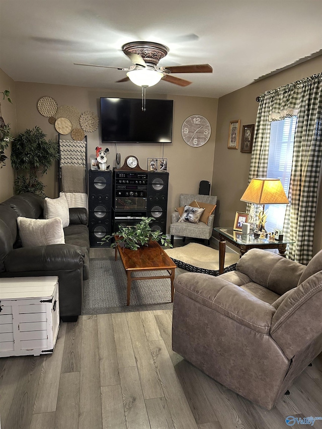 living room featuring ceiling fan and light wood-type flooring