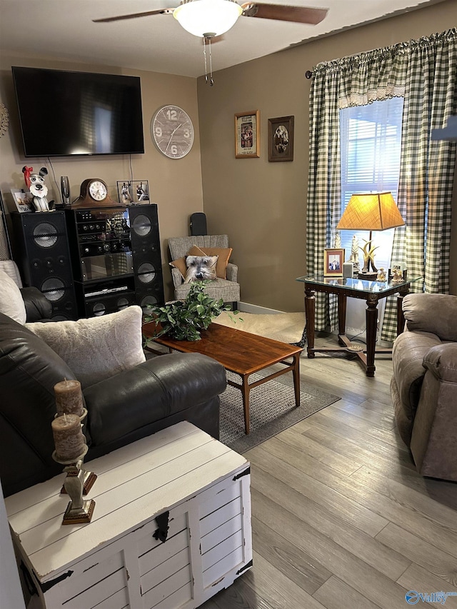 living room featuring ceiling fan and light hardwood / wood-style flooring