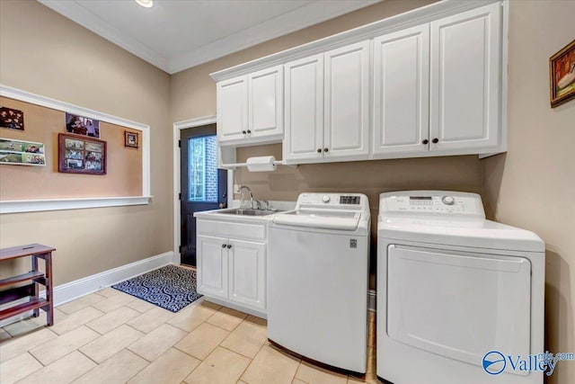 washroom with washing machine and clothes dryer, crown molding, baseboards, cabinet space, and a sink