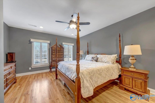 bedroom featuring visible vents, baseboards, ceiling fan, and light wood finished floors