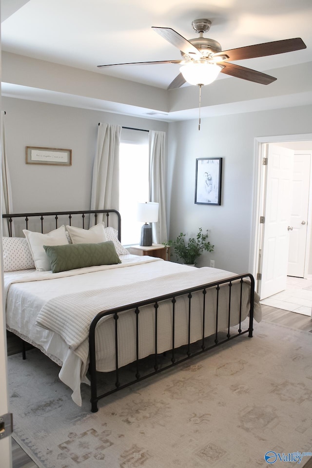 bedroom featuring ceiling fan and light carpet