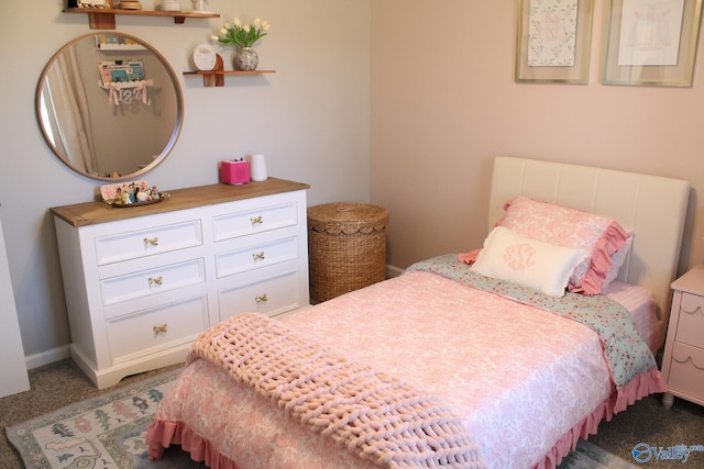 bedroom with dark colored carpet