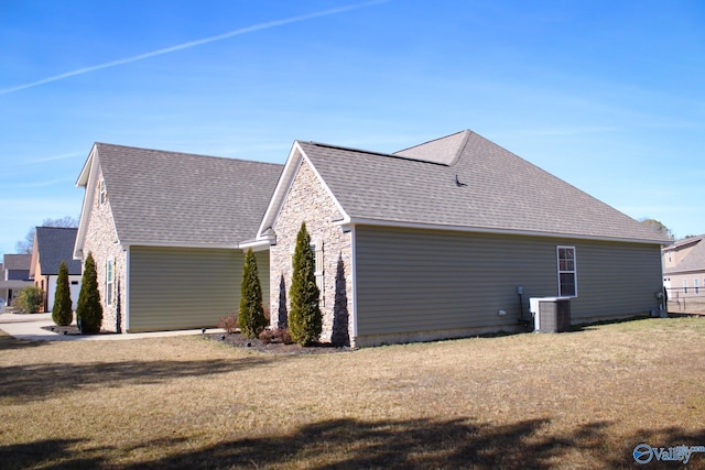 view of home's exterior featuring a yard and central AC unit