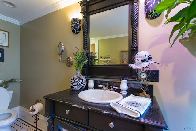 bathroom with vanity, toilet, tile patterned floors, and ornamental molding