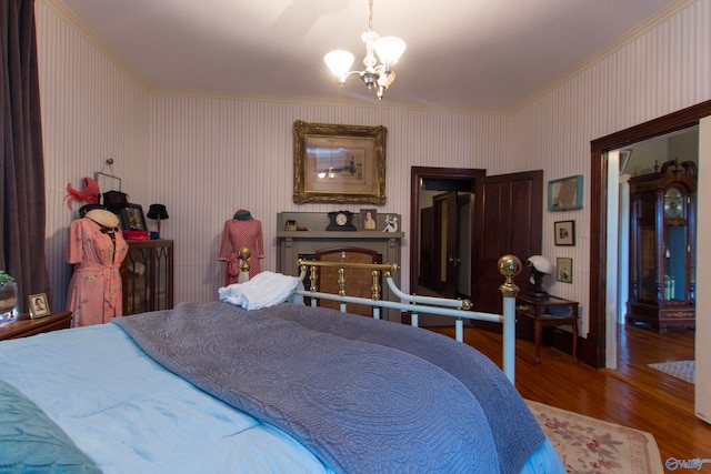 bedroom featuring crown molding, hardwood / wood-style floors, and a chandelier