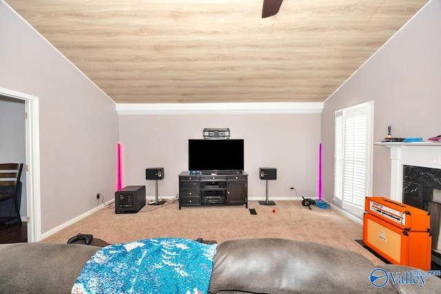 carpeted living room with a fireplace, baseboards, vaulted ceiling, and crown molding