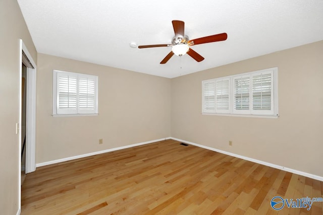 unfurnished bedroom featuring a closet, baseboards, light wood-style floors, visible vents, and ceiling fan