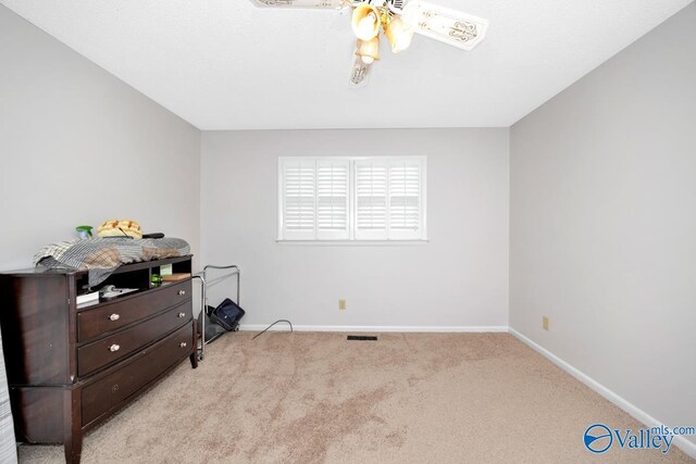 bedroom with carpet, visible vents, baseboards, and ceiling fan