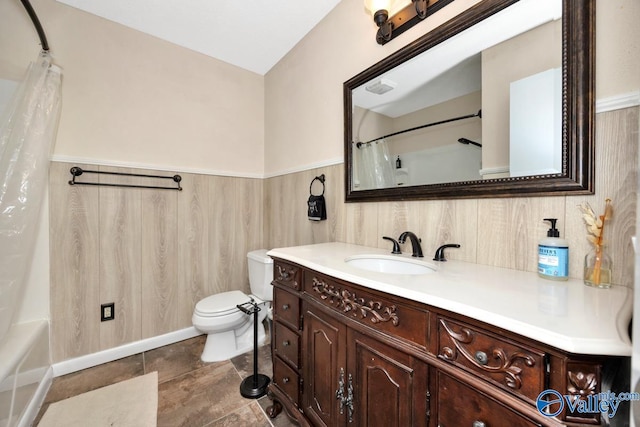 bathroom featuring vanity, a wainscoted wall, visible vents, and toilet